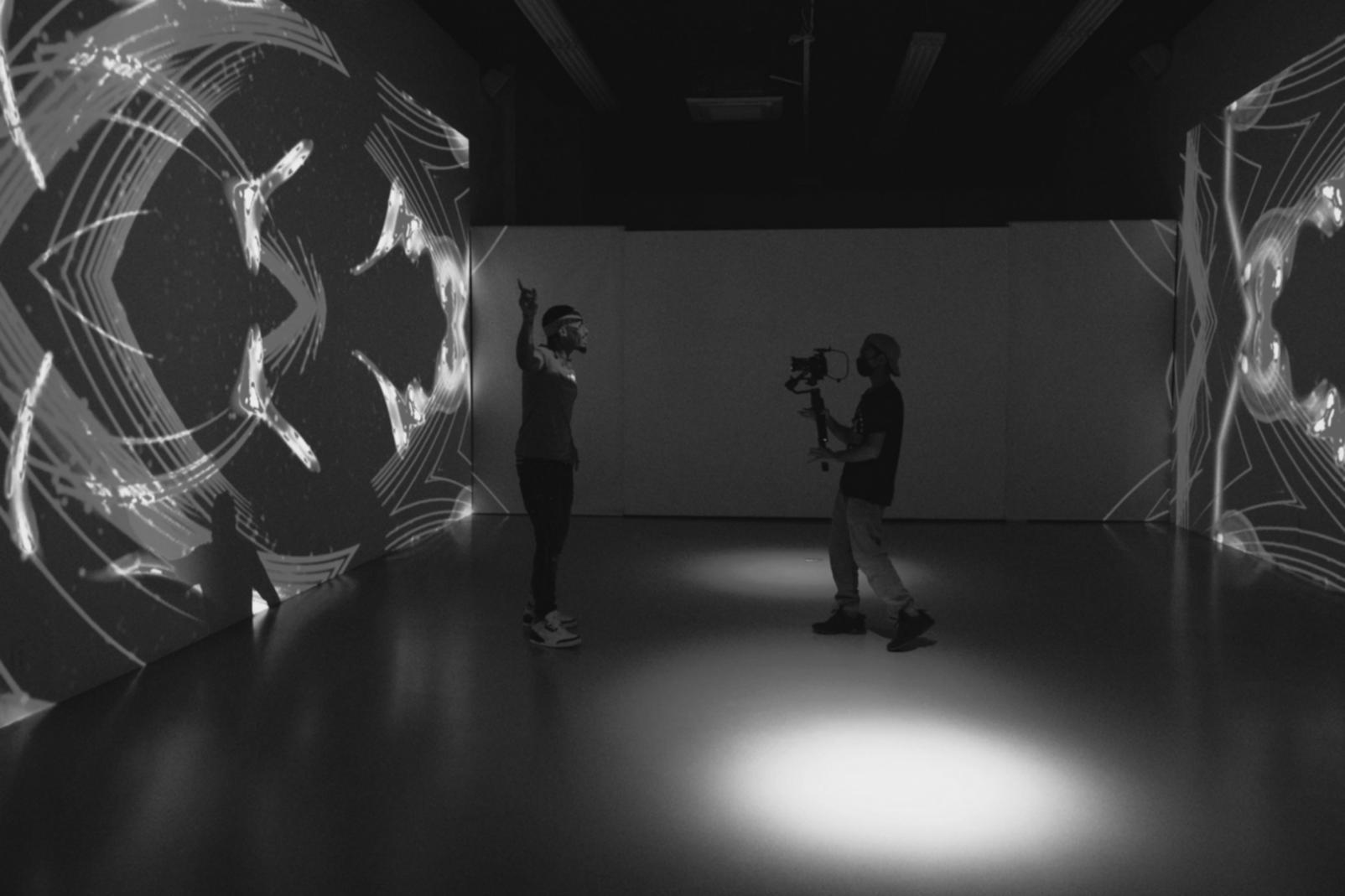 Team collaboration session with multiple monitors showing video editing workflow